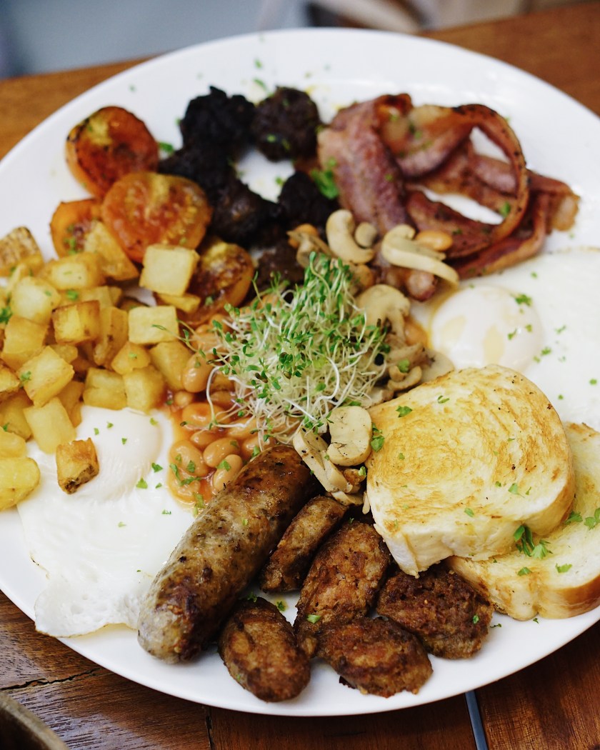 Big Breakfast Platter (Hungarian, Italian, and Pinoy dinuguan sausages, 2 sunny-side-up eggs, potato hash, toasted brioche, roasted button mushrooms, bacon strips, pork & beans, and roasted tomatoes) Php 595